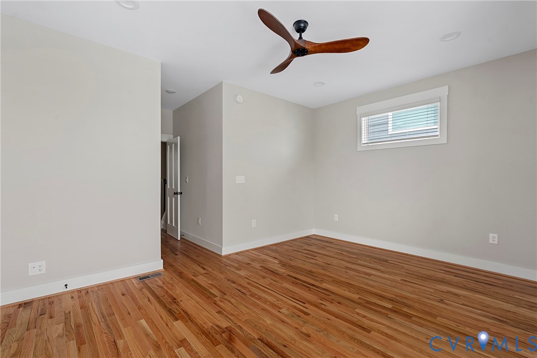 2909 R Street Richmond, VA 23223 - Photo 44 of 50 an empty room with wooden floor and windows