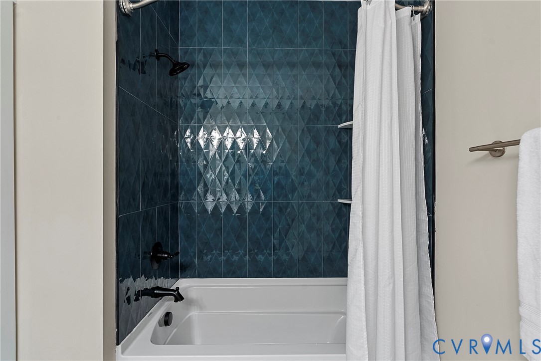2909 R Street Richmond, VA 23223 - Photo 46 of 50 a bathroom with a bathtub and shower