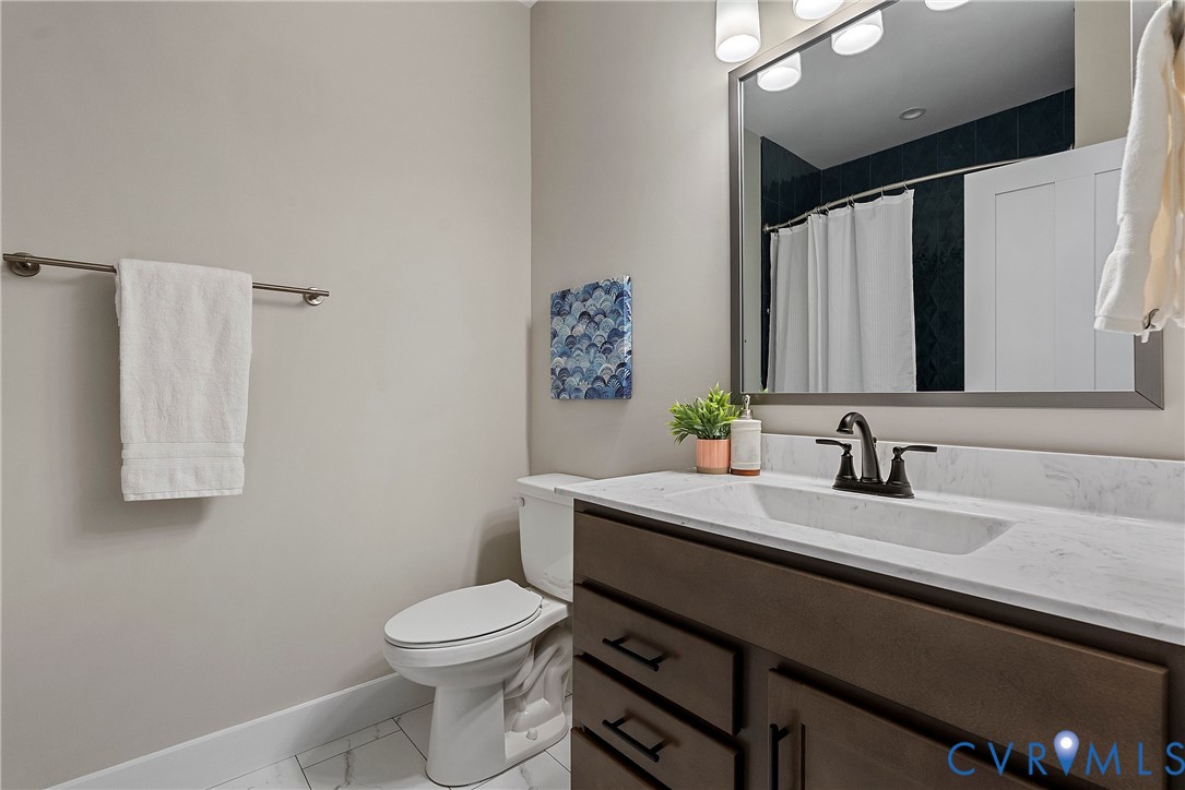 2909 R Street Richmond, VA 23223 - Photo 47 of 50 a bathroom with a granite countertop sink toilet and mirror