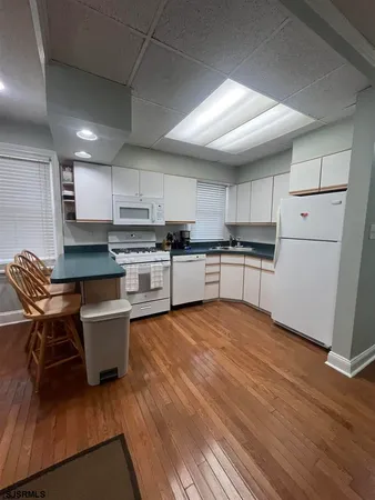 a kitchen with stainless steel appliances granite countertop a refrigerator sink and cabinets