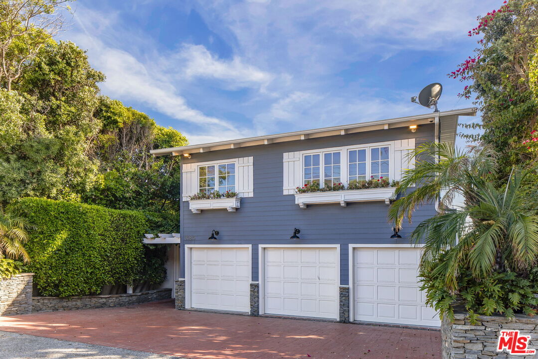 30810 Broad Beach Road Malibu, CA 90265 - Photo 40 of 43 a front view of a house with a garden