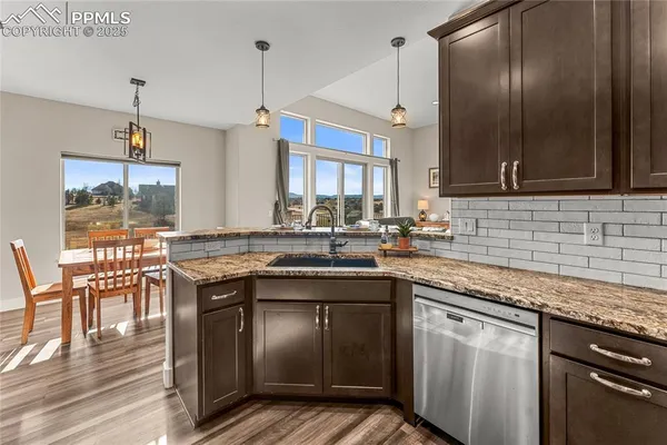 a kitchen with stainless steel appliances granite countertop a sink stove and cabinets