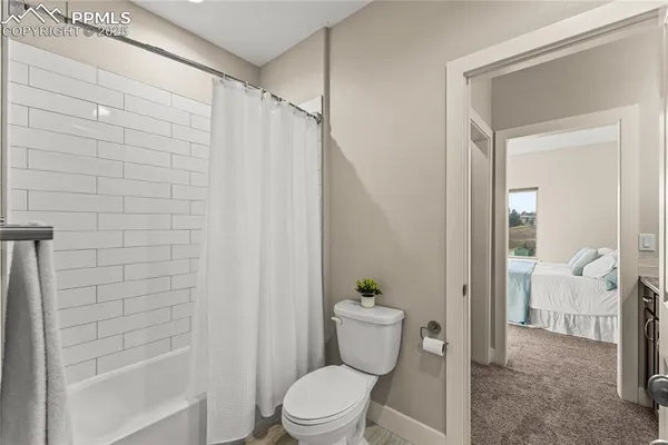 a bathroom with a toilet and shower