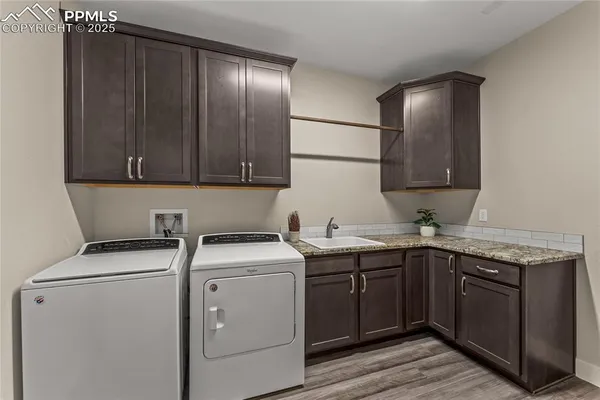 a utility room with sink and cabinets