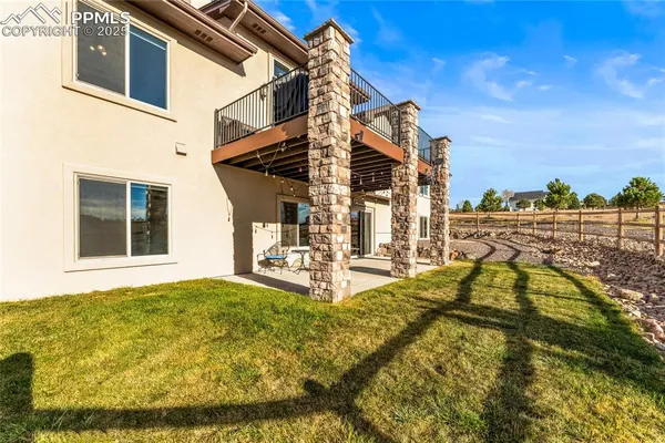 a view of an house with backyard and swimming pool
