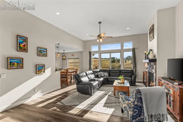 a living room with furniture a flat screen tv and a large window