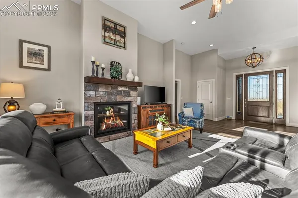 a living room with furniture a flat screen tv and a fireplace