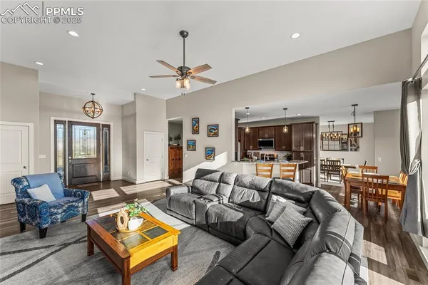 a living room with furniture a chandelier and a table