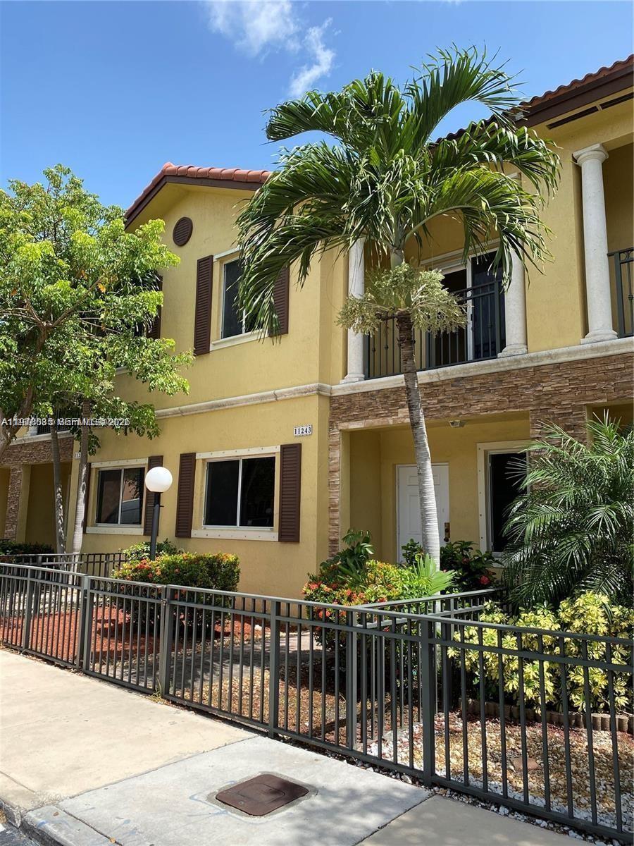 a view of a white building among the palm tree