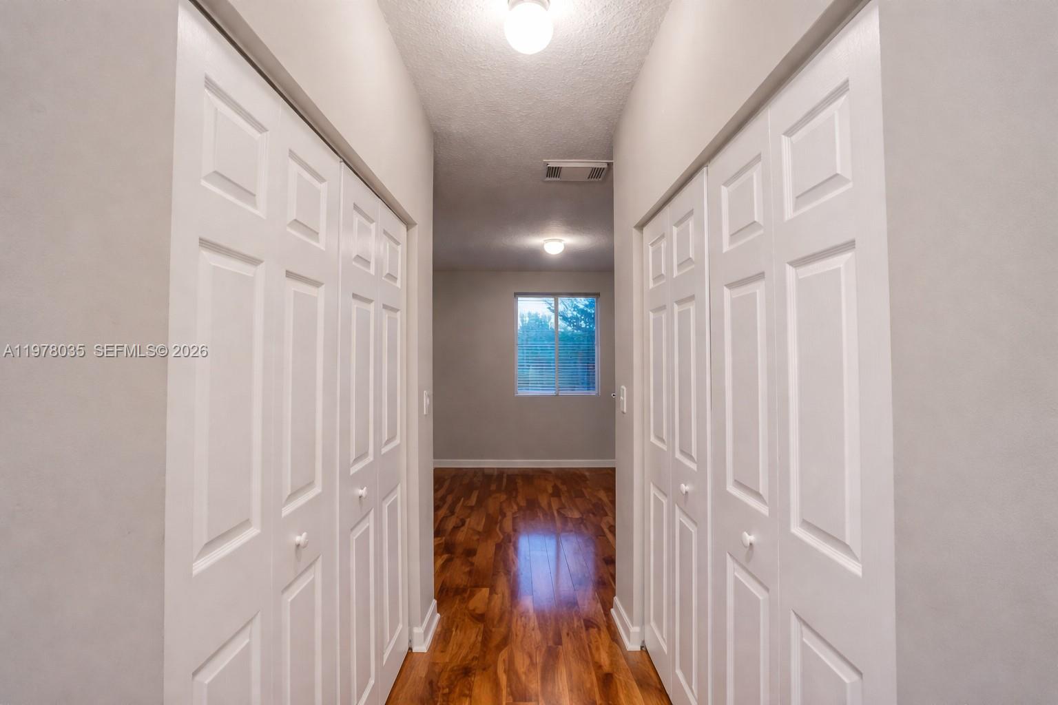 11243 Southwest 230th Terrace Miami, FL 33170 - Photo 11 of 22 a view of a hallway with wooden floor and staircase