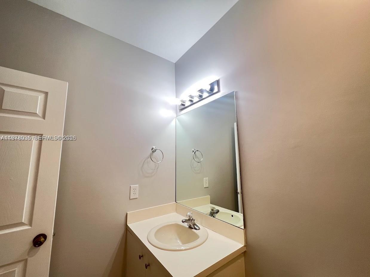 11243 Southwest 230th Terrace Miami, FL 33170 - Photo 15 of 22 a bathroom with a sink and a mirror