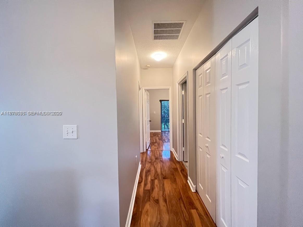 11243 Southwest 230th Terrace Miami, FL 33170 - Photo 18 of 22 a view of a hallway with wooden floor