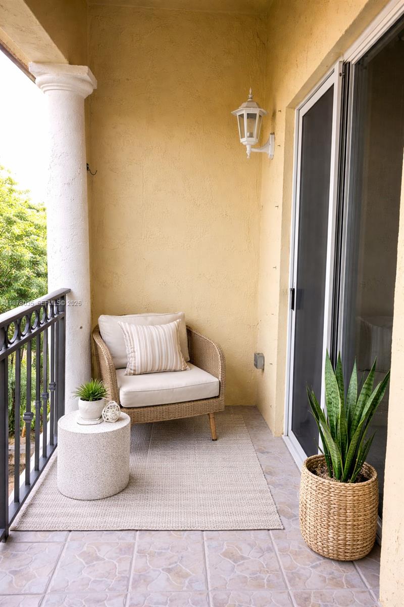 11243 Southwest 230th Terrace Miami, FL 33170 - Photo 20 of 22 a view of a balcony with chair and potted plants