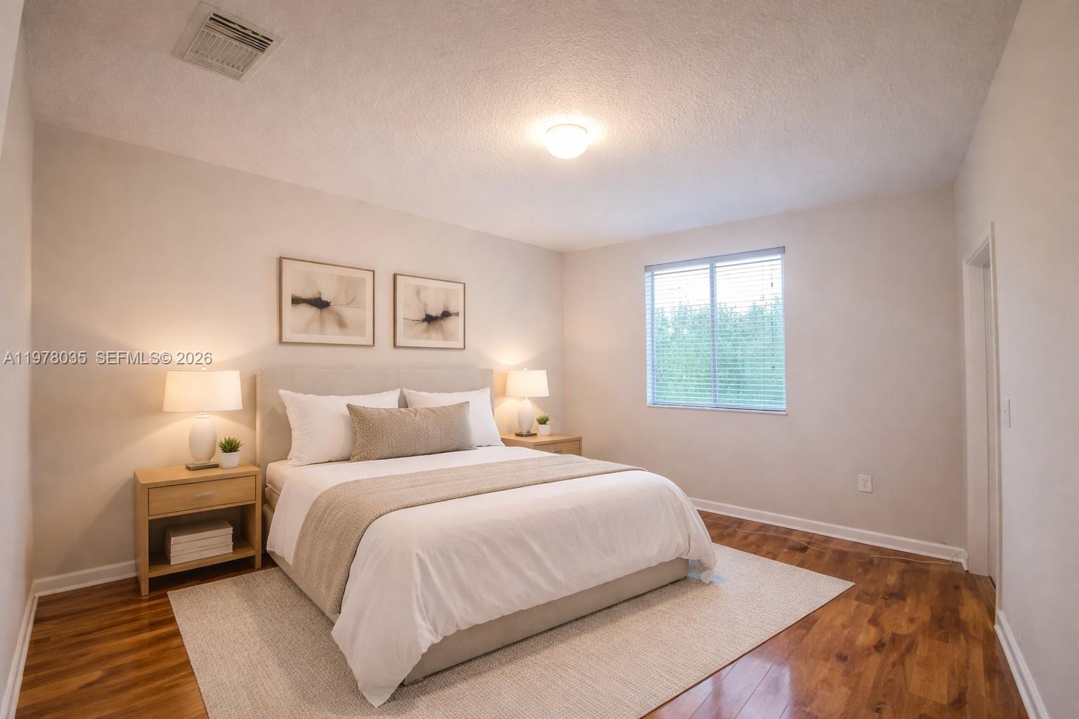 11243 Southwest 230th Terrace Miami, FL 33170 - Photo 6 of 22 a bedroom with a bed and a night stand