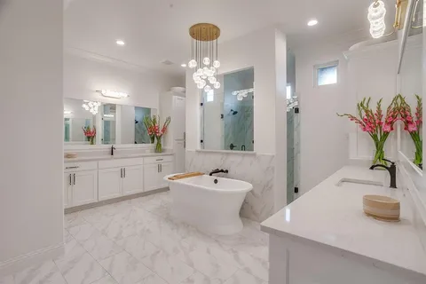 a bathroom with a sink a tub and a mirror