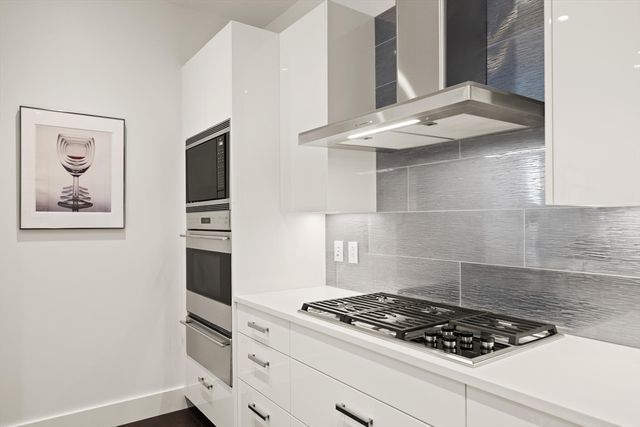 a stove top oven sitting inside of a kitchen