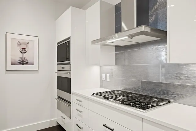 a stove top oven sitting inside of a kitchen