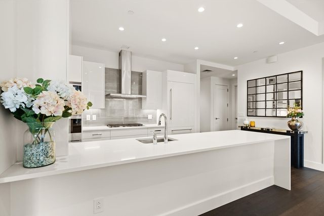 a bathroom with a double vanity sink mirror and flower