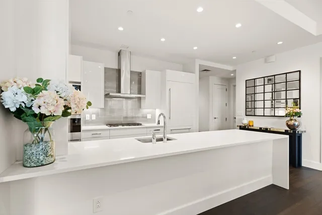 a bathroom with a double vanity sink mirror and flower