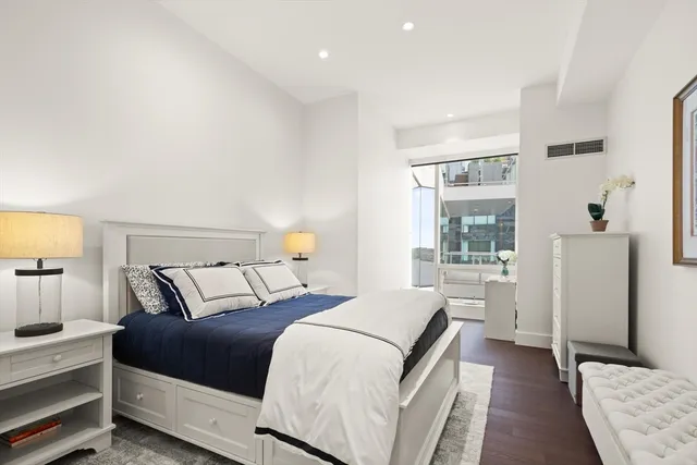 a bedroom with a bed and a night stand