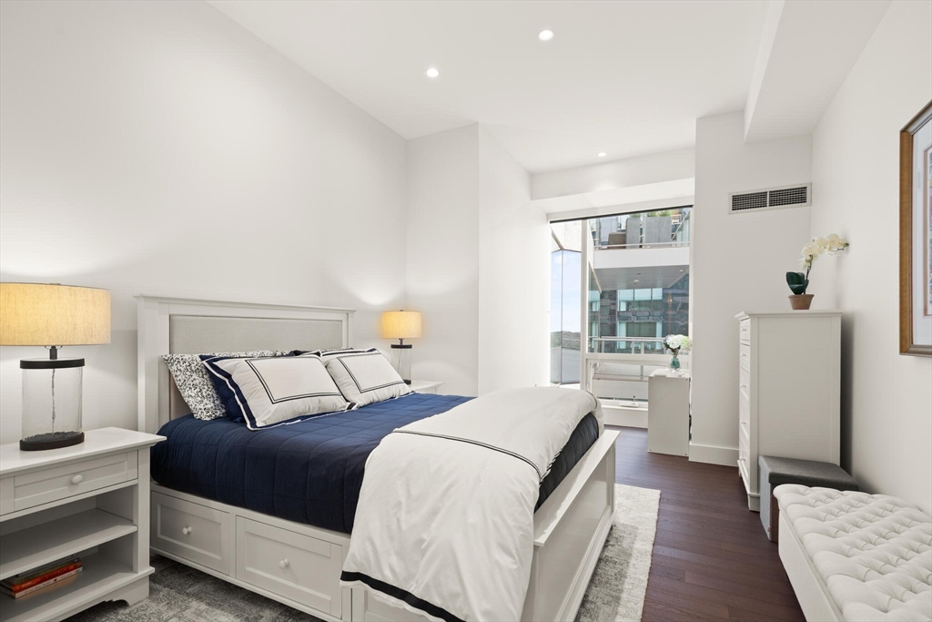 50 Liberty Drive, Unit 11L Boston, MA 02210 - Photo 17 of 40 a bedroom with a bed and a night stand