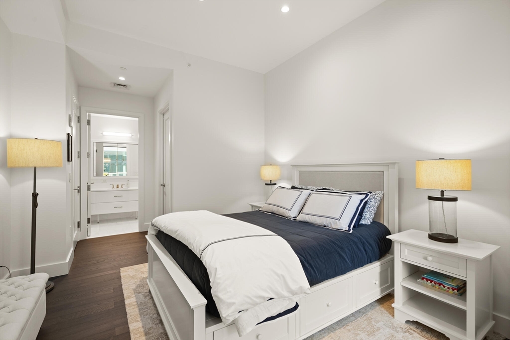 50 Liberty Drive, Unit 11L Boston, MA 02210 - Photo 19 of 40 a bedroom with a bed and a lamp