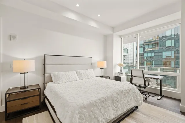 a bedroom with a bed and a lamp