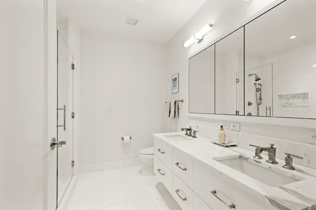 a bathroom with a double vanity sink mirror and double