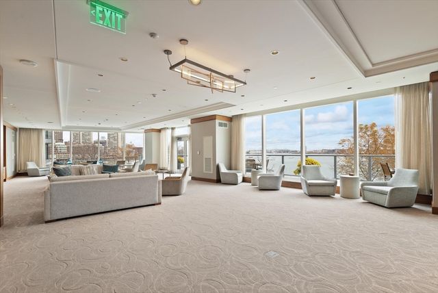 a living room with furniture and large windows