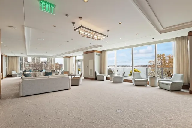 a living room with furniture and large windows