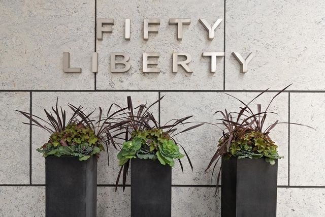 a vase of flowers sitting on a granite counter