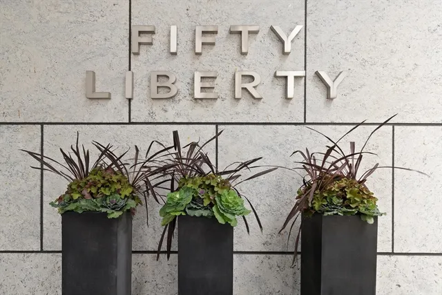 a vase of flowers sitting on a granite counter
