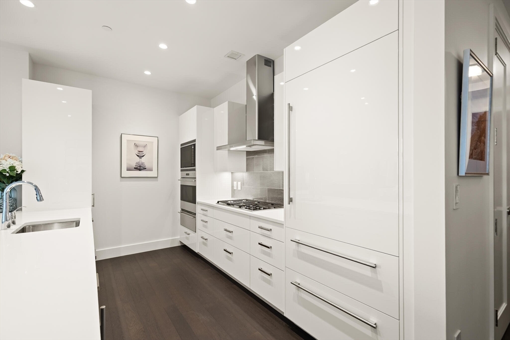 50 Liberty Drive, Unit 11L Boston, MA 02210 - Photo 10 of 40 a kitchen with cabinets and wooden floor