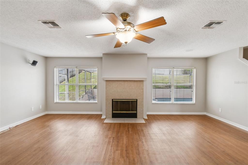 1854 Ridge Valley Street Clermont, FL 34711 - Photo 12 of 73 a view of an empty room with wooden floor fireplace and a window