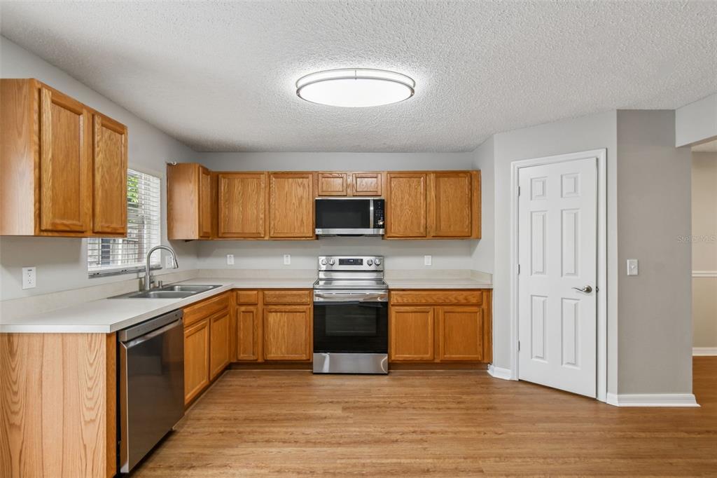1854 Ridge Valley Street Clermont, FL 34711 - Photo 17 of 73 a kitchen with stainless steel appliances granite countertop a stove sink and cabinets