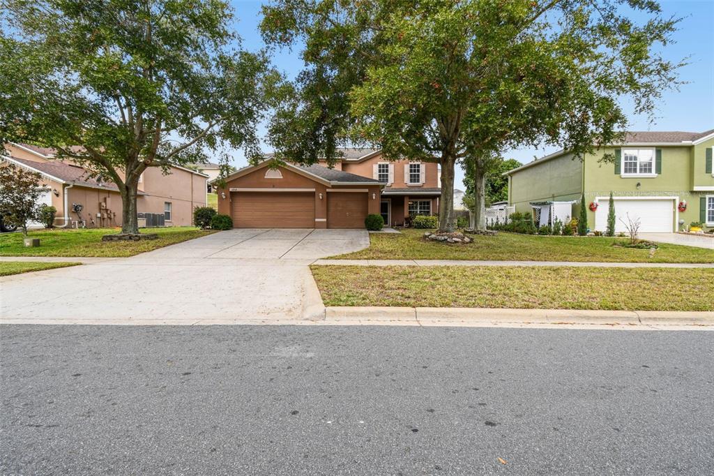 1854 Ridge Valley Street Clermont, FL 34711 - Photo 3 of 73 a front view of a house with a yard and garage