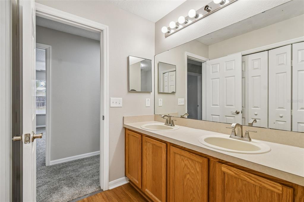 1854 Ridge Valley Street Clermont, FL 34711 - Photo 40 of 73 a bathroom with a sink and a mirror