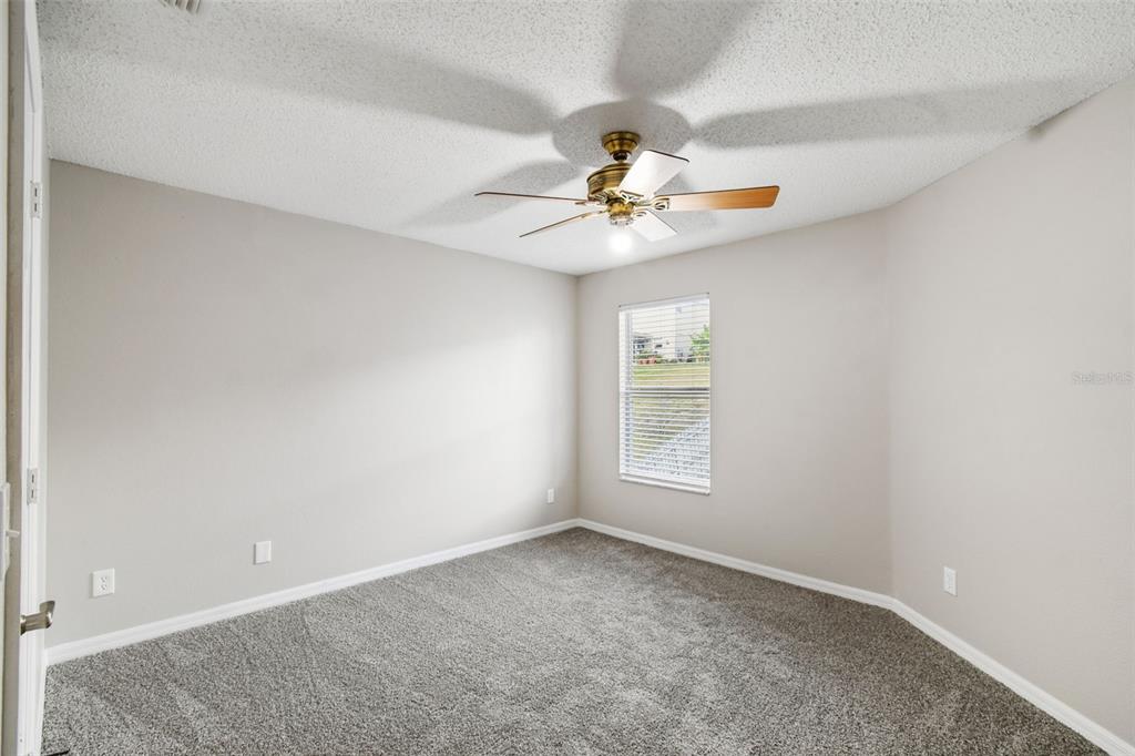 1854 Ridge Valley Street Clermont, FL 34711 - Photo 44 of 73 an empty room with windows and chandelier fan