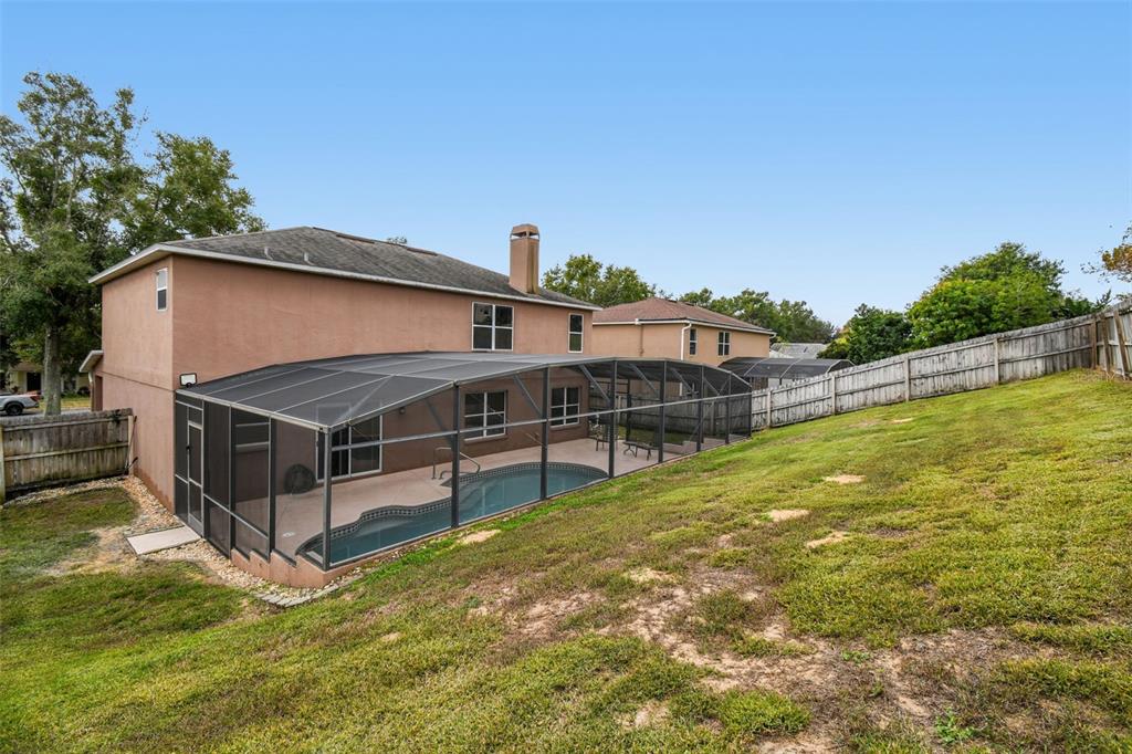 1854 Ridge Valley Street Clermont, FL 34711 - Photo 56 of 73 a view of a house with a backyard and a patio
