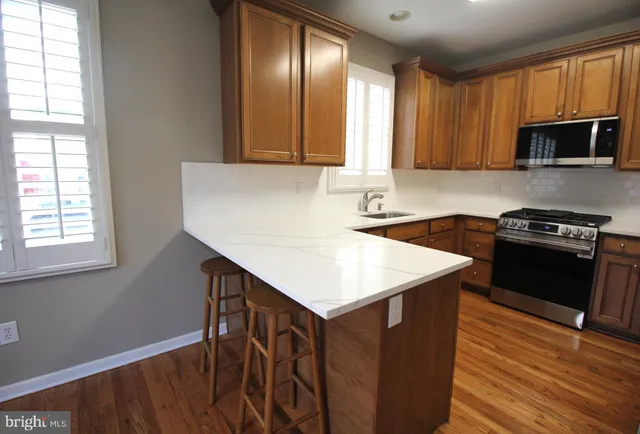 a kitchen with a sink stove and microwave