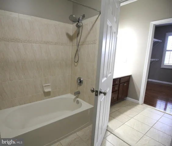 a bathroom with a tub a sink and a shower