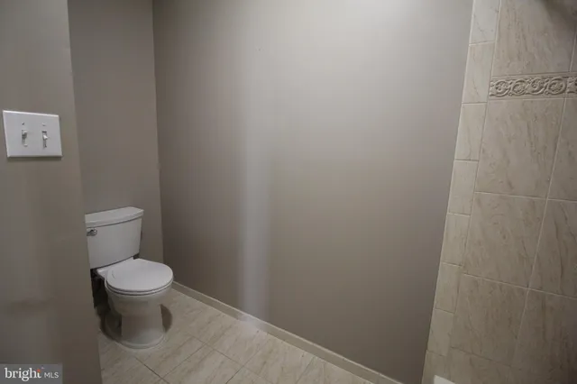 a white toilet sitting next to a small bathroom