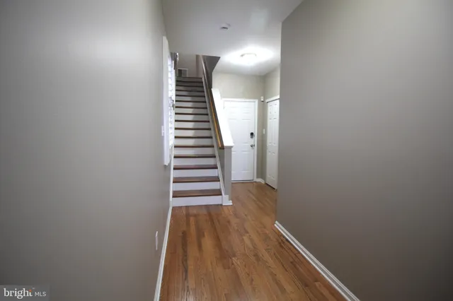 a view of a hallway with wooden floor