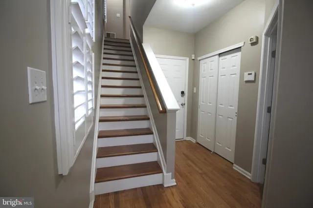 a view of entryway with wooden floor and stairs