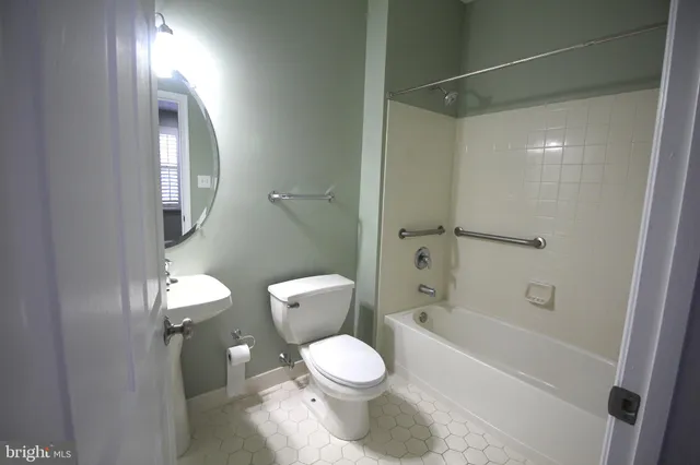 a bathroom with a toilet a sink and bathtub