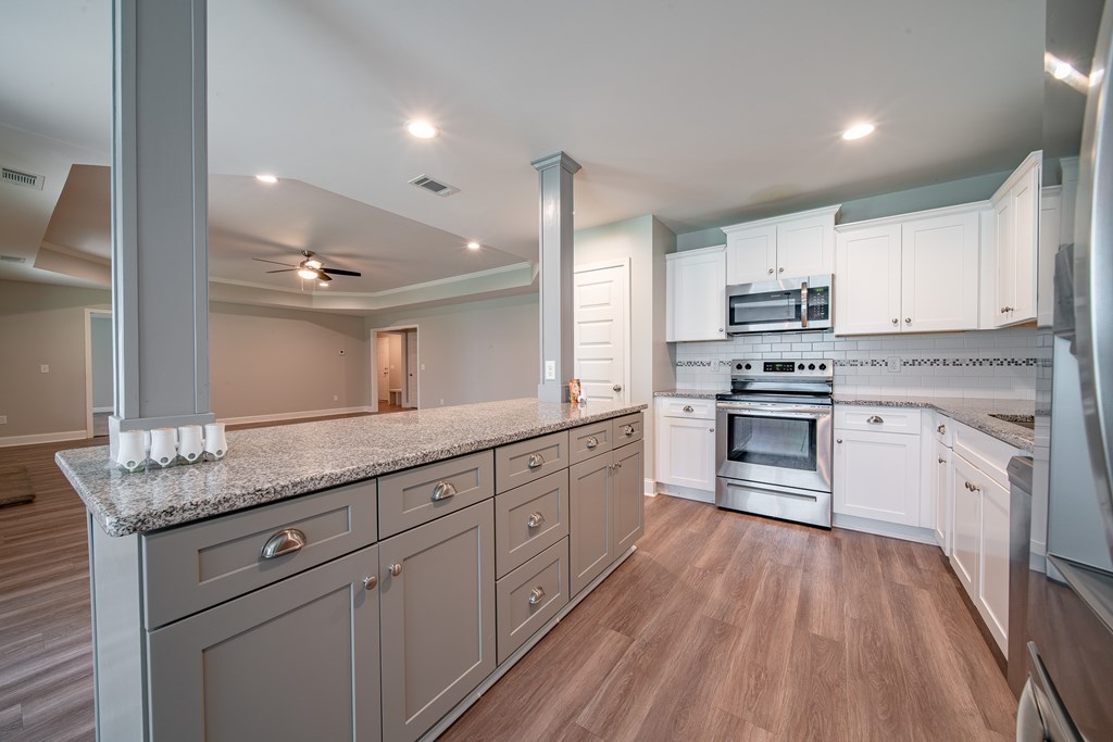 16 Maxwell Drive Fort Mitchell, AL 36856 - Photo 22 of 25 a kitchen with kitchen island granite countertop white cabinets and stainless steel appliances