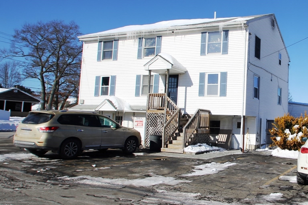 299 Main Street, Unit 2 North Reading, MA 01864 - Photo 2 of 35 a car parked in front of a white house