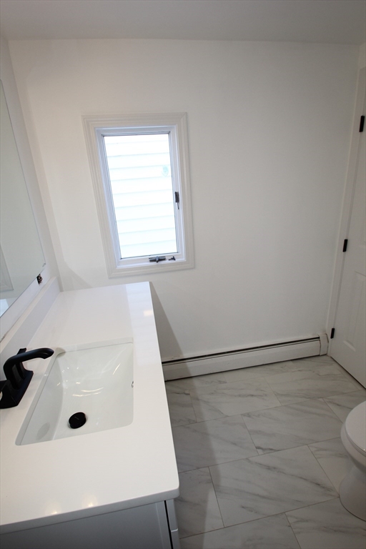 299 Main Street, Unit 2 North Reading, MA 01864 - Photo 21 of 35 a bathroom with a sink a toilet and shower