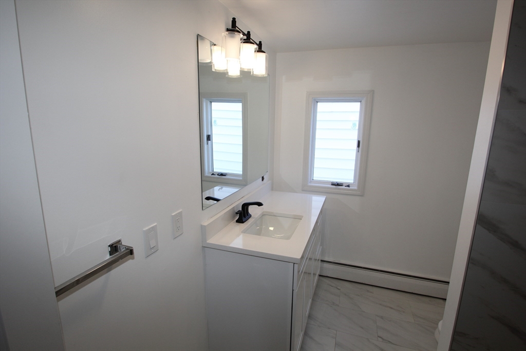299 Main Street, Unit 2 North Reading, MA 01864 - Photo 22 of 35 a bathroom with a sink a window and shower