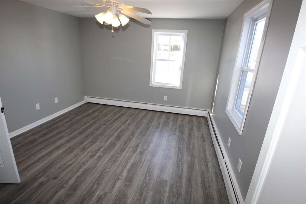 299 Main Street, Unit 2 North Reading, MA 01864 - Photo 31 of 35 a view of a room with wooden floors and window